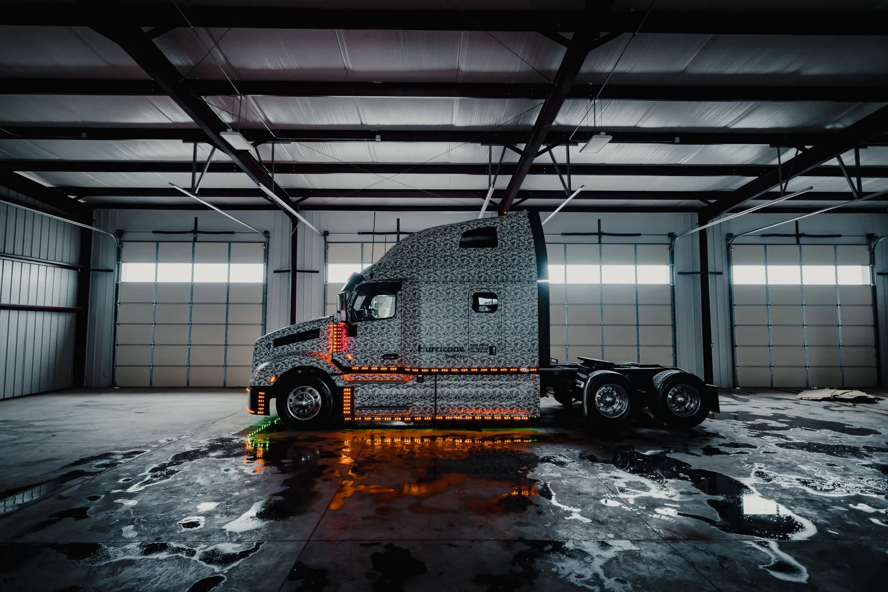 Custom semi-truck photographed inside an industrial garage