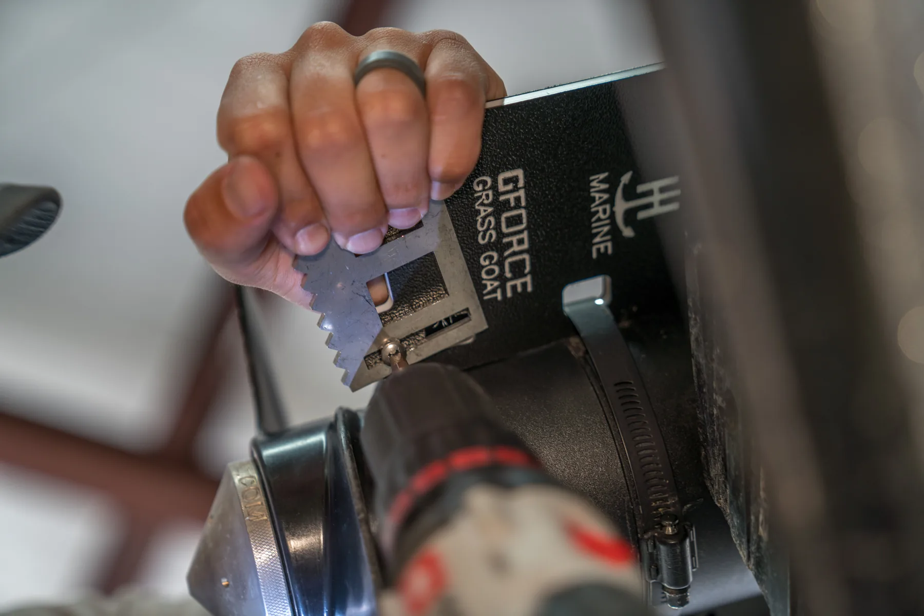 Hand operating a TH Marine boating accessory in a working environment