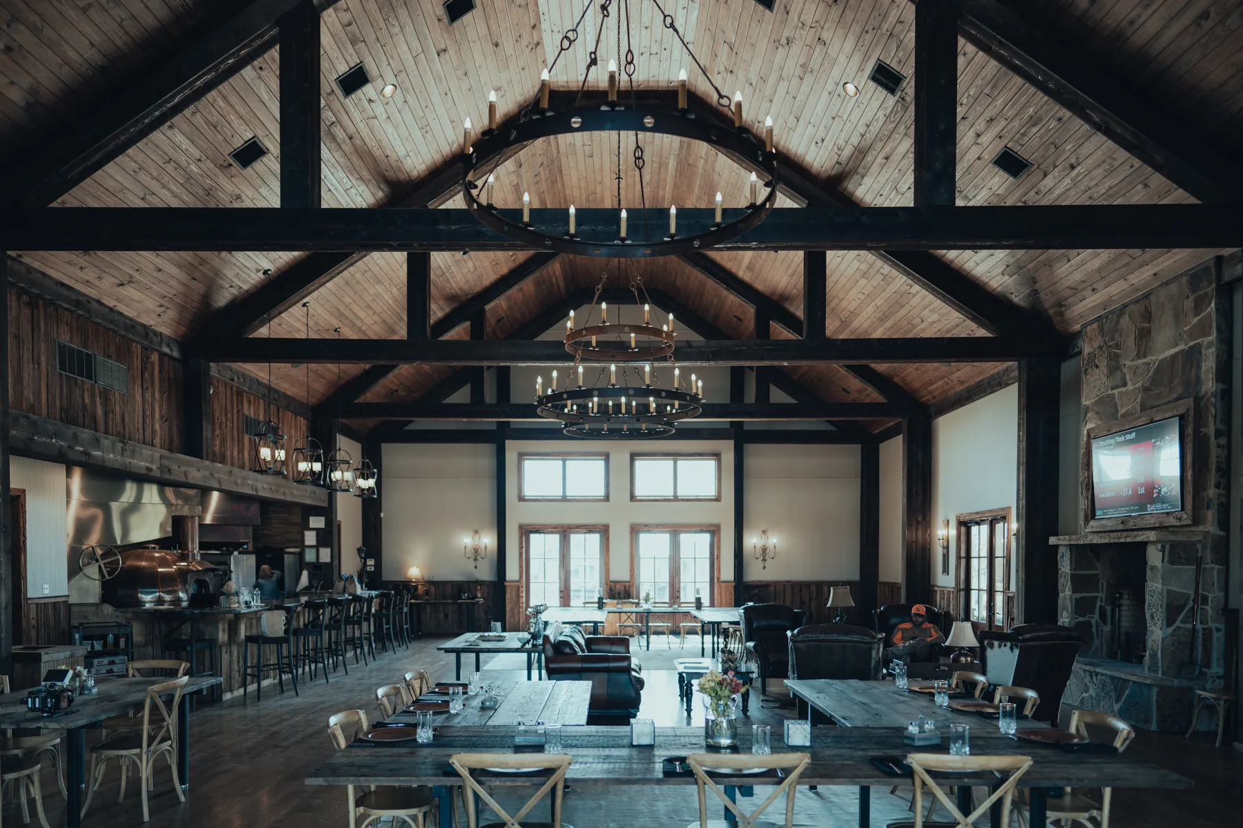 Warmly lit dining hall at Otter Creek with exposed timber beams