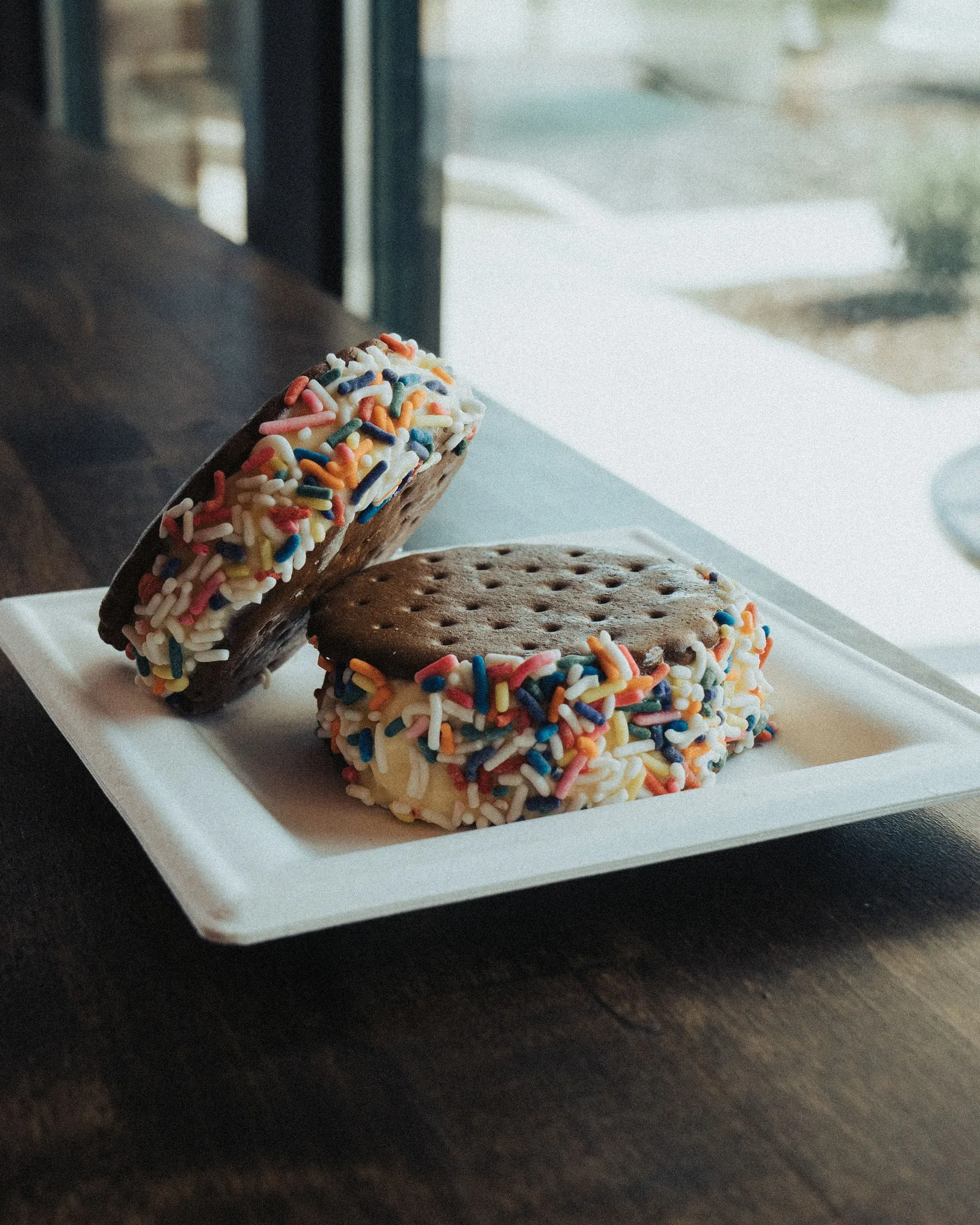 Two sprinkle-covered ice cream sandwiches at Seven Daughters Scoops