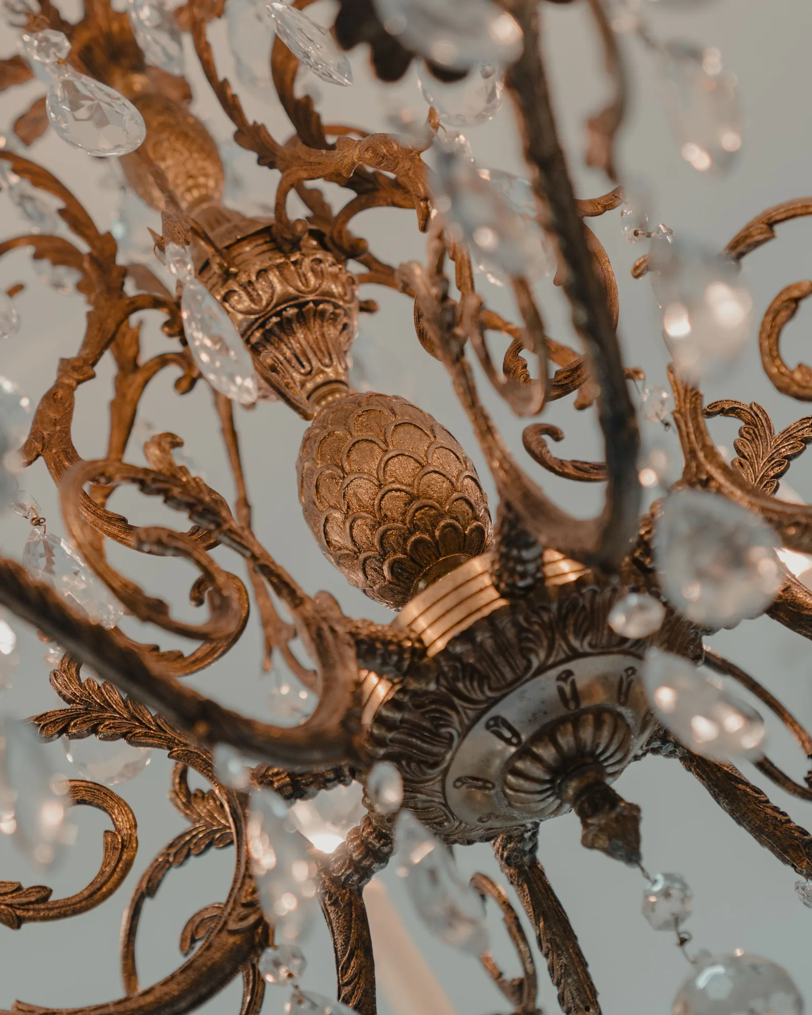 Close view of an ornate chandelier with crystal and brass details